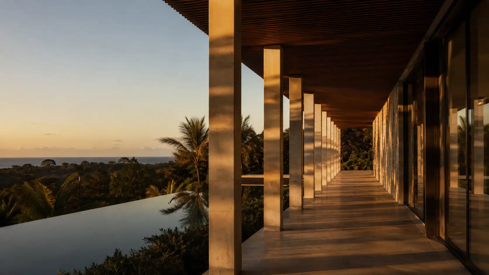 Modern villa corridor at sunset with infinity pool and sea view